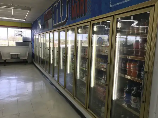 A lit convenience-store cooler aisle