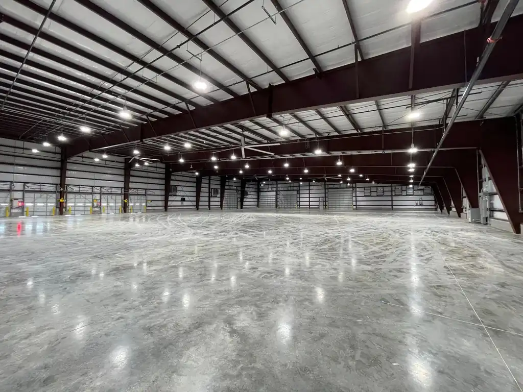 A finished warehouse interior, high bay lighting on and the slab polished